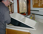 plumber in Pittsburg CA installs a new kitchen sink
