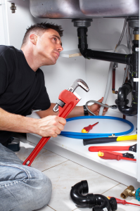 contractor handles plumbing in pittsburg ca with a pipe wrench